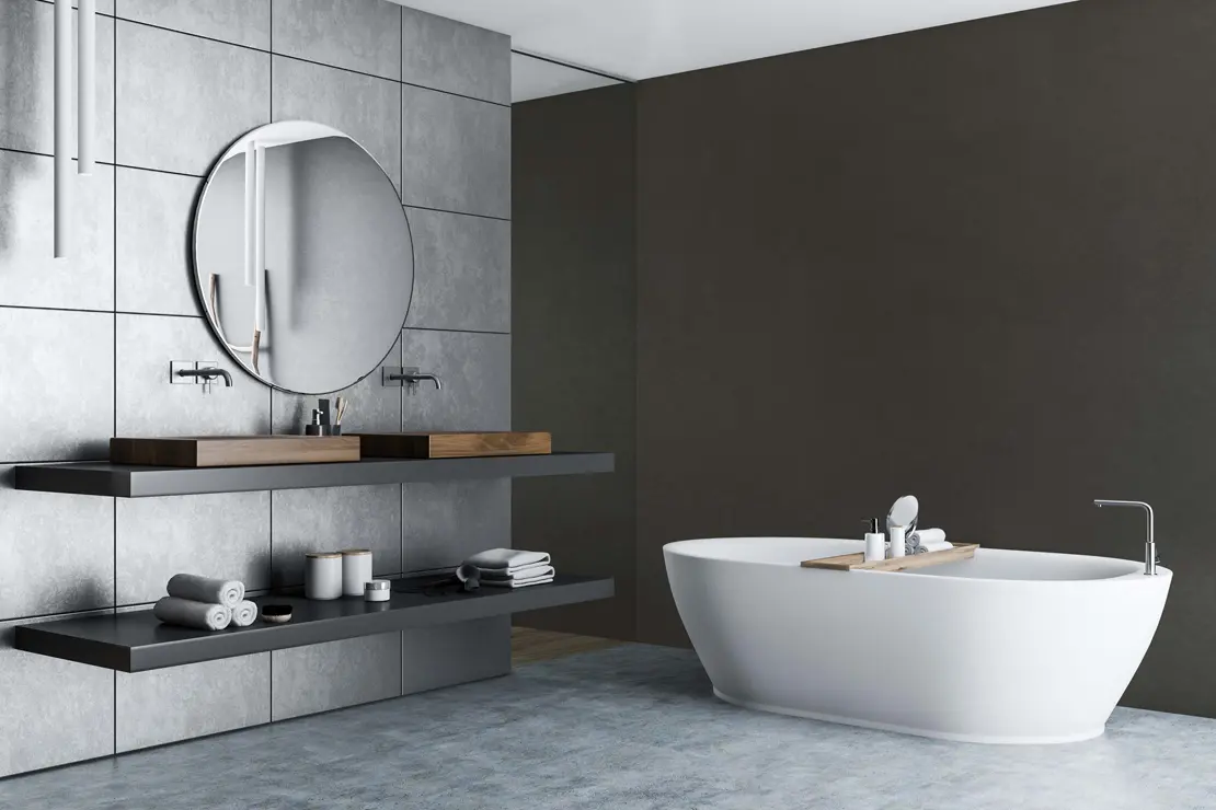 Baño con muros de microcemento de color gris intenso.